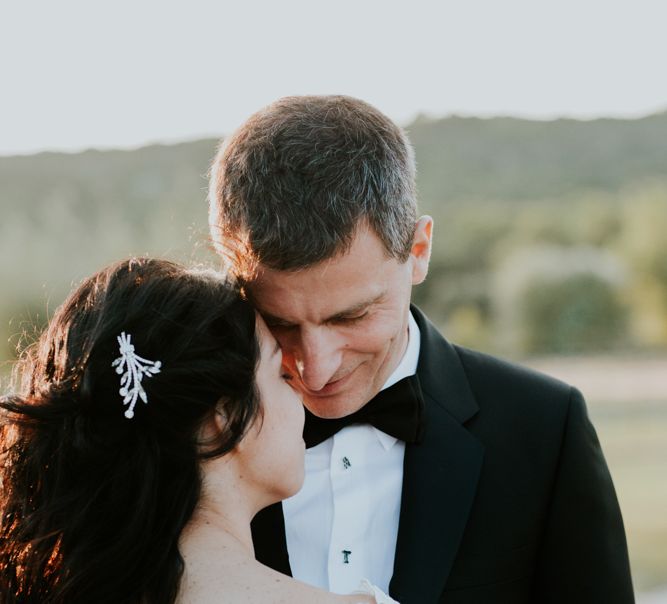 Bride in Appliqué Caroline Castigliano Wedding Dress and Groom in Tuxedo Embracing