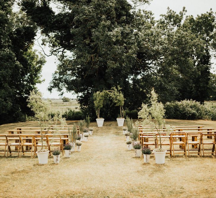 Outdoor Wedding Ceremony Set-up at Fishley Hall | Wedding Arch Sculpted from Trees | Aisle Lined with Potted Shrubbery and Trees | Outdoor Ceremony at Fishley Hall with Grace Loves Lace Fringe Dress | Darina Stoda Photography