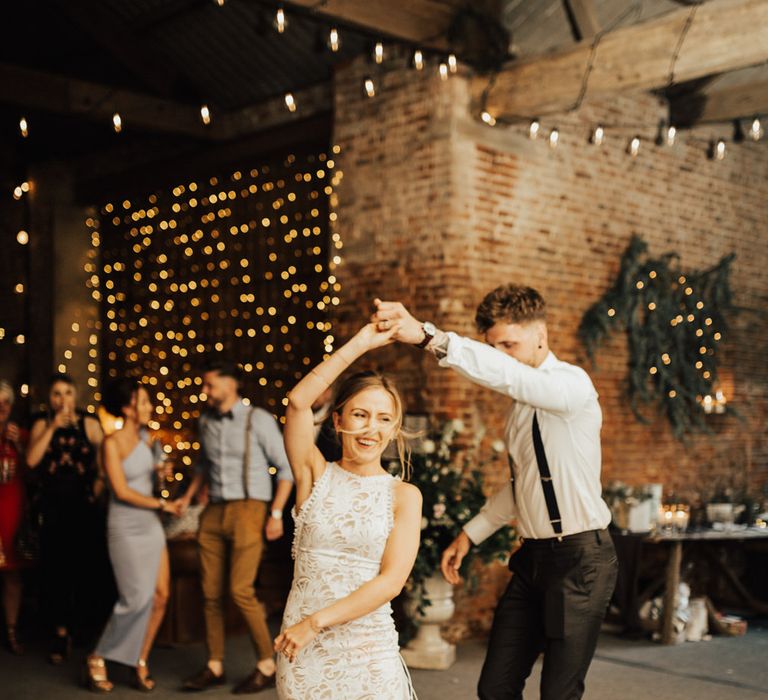 First Dance | Bride in Embroidered Grace Loves Lace Gown with Fringing and Cut Out Back | Groom in Black Gagliardi Suit with Bow Tie and Braces | Fairylight Canopy | Festoon Lights | Outdoor Ceremony at Fishley Hall with Grace Loves Lace Fringe Dress | Darina Stoda Photography