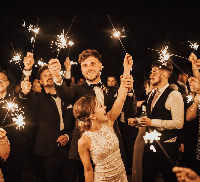 Sparkler Send Off | Bride in Embroidered Grace Loves Lace Gown with Fringing and Cut Out Back | Groom in Black Gagliardi Suit with Bow Tie and Braces | Outdoor Ceremony at Fishley Hall with Grace Loves Lace Fringe Dress | Darina Stoda Photography