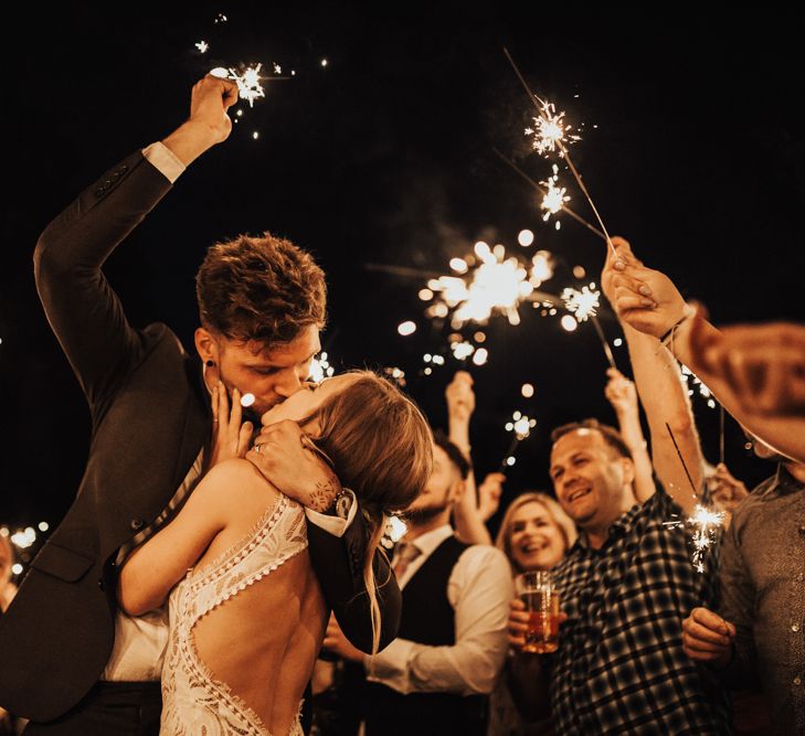 Wedding Sparklers | Bride in Embroidered Grace Loves Lace Gown with Fringing and Cut Out Back | Groom in Black Gagliardi Suit with Bow Tie and Braces | Outdoor Ceremony at Fishley Hall with Grace Loves Lace Fringe Dress | Darina Stoda Photography