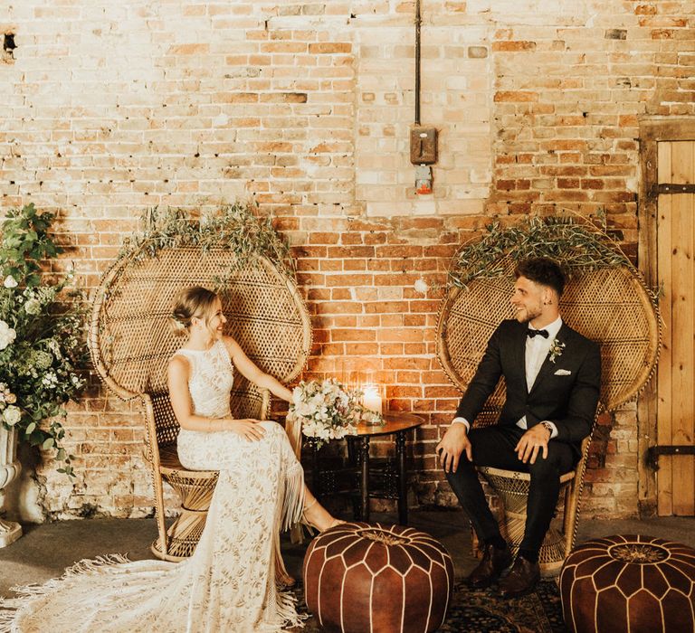 Peacock Chairs Decorated with Foliage | Bride in Embroidered Grace Loves Lace Gown with Fringing and Cut Out Back | Groom in Black Gagliardi Suit with Bow Tie and Braces | Outdoor Ceremony at Fishley Hall with Grace Loves Lace Fringe Dress | Darina Stoda Photography