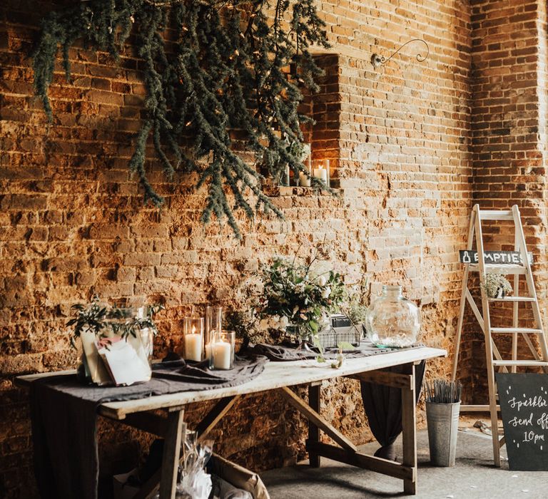 Wedding Reception Décor | Rustic Table with Dark Grey Runner | Pillar Candles | Foliage | Advice Cards | Stepladder | Urn Filled with Sparklers | Outdoor Ceremony at Fishley Hall with Grace Loves Lace Fringe Dress | Darina Stoda Photography