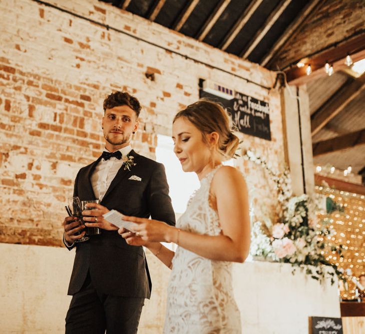 Bride and Groom Speech | Bride in Embroidered Grace Loves Lace Gown with Fringing and Cut Out Back | Groom in Black Gagliardi Suit with Bow Tie and Braces | Outdoor Ceremony at Fishley Hall with Grace Loves Lace Fringe Dress | Darina Stoda Photography