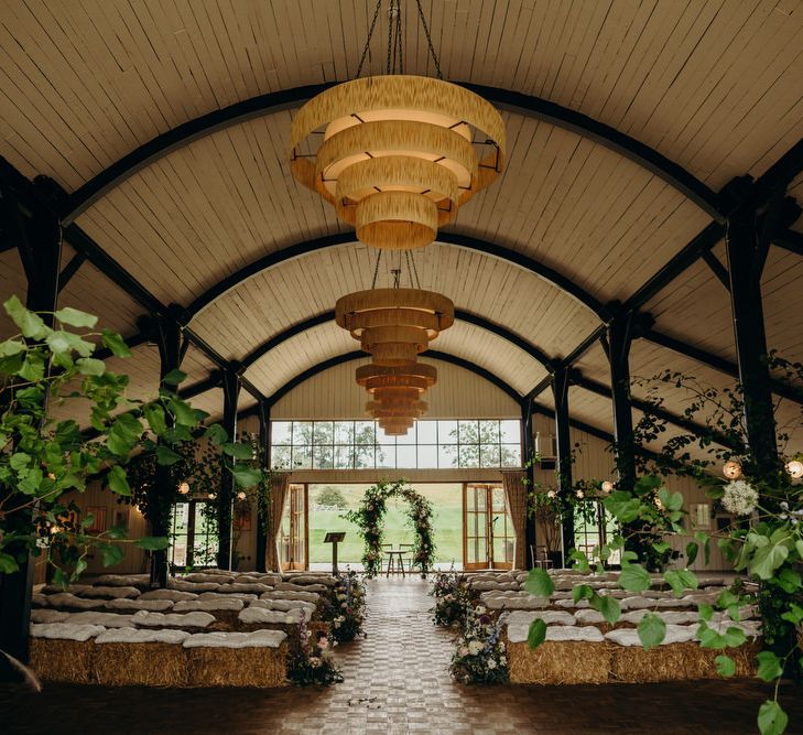 Ceremony at Soho Farmhouse with hay bale seating