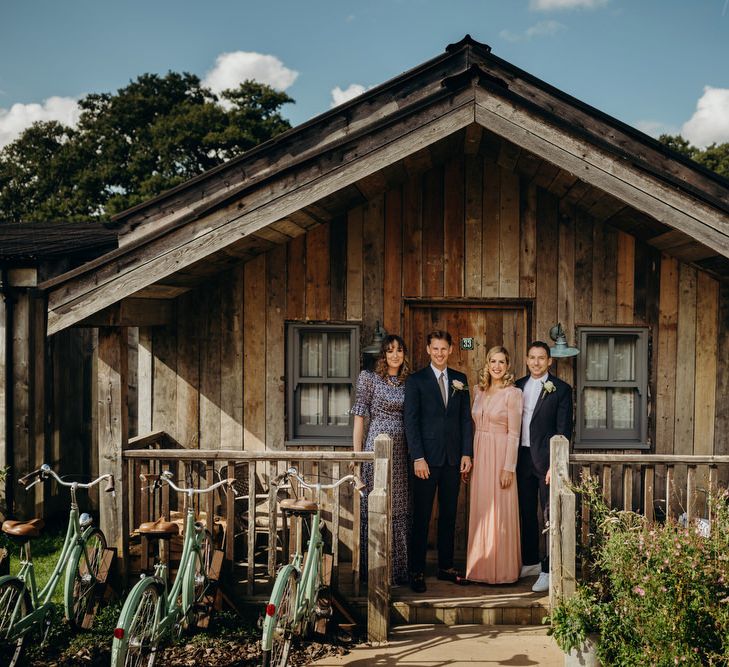 Groom in Navy Suit with Wedding Guests