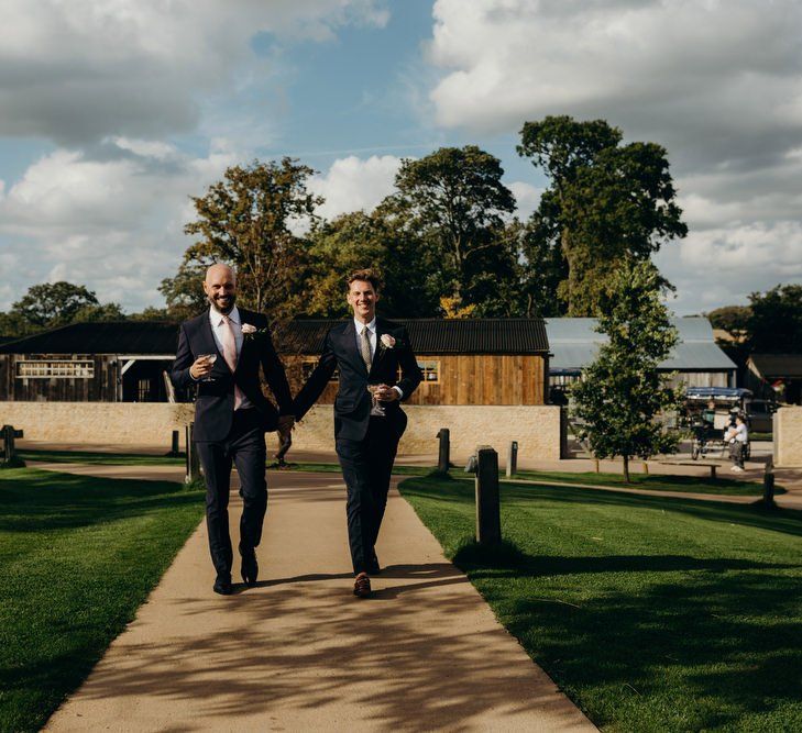 Same Sex Couple Holding Hands Outside Their Soho Farmhouse Wedding Venue