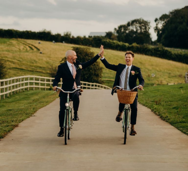 Same Sex Couple Portrait on Bicycles at Soho Farmhouse Wedding