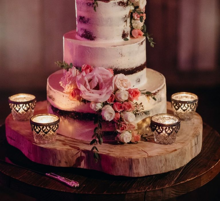 Semi Naked Cake Decorated with Flower and Candles on Tree Slice Cake Stand