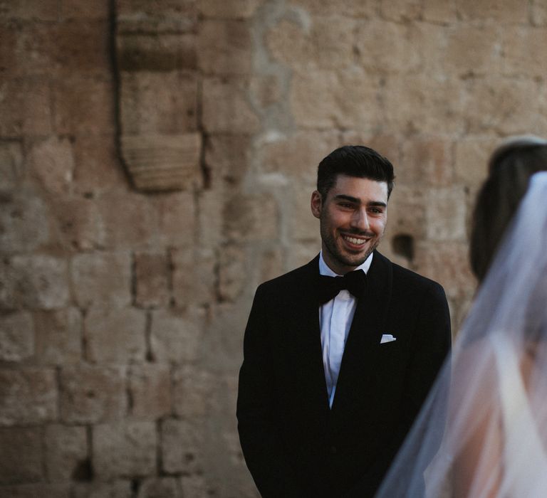 Wedding Ceremony | Groom in Made to Measure Tuxedo Suit by Oscar Hunt | Black Aquila Shoes | Bride in Silk Pallas Couture Wedding Dress with Plunging Neckline and Side Split | Roman &amp; French Cathedral Veil |Intimate Italian Castle Wedding with Prosecco Tower | James Frost Photography