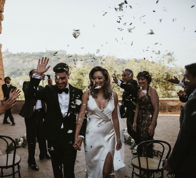 Confetti Throw | Newlyweds | Bride in Silk Pallas Couture Wedding Dress with Plunging Neckline and Side Split | Groom in Made to Measure Tuxedo Suit by Oscar Hunt | Intimate Italian Castle Wedding with Prosecco Tower | James Frost Photography