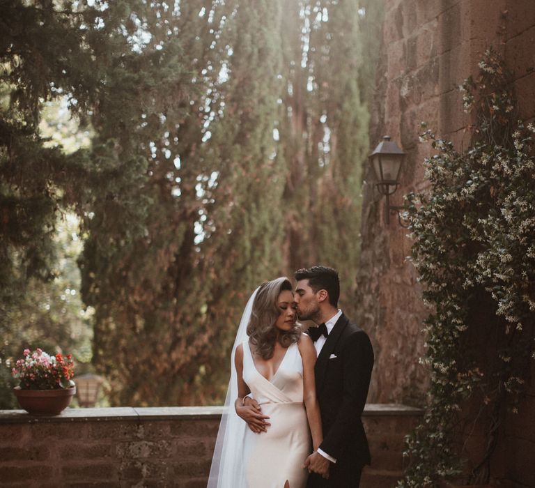 Bride in Silk Pallas Couture Wedding Dress with Plunging Neckline and Side Split | Roman &amp; French Cathedral Veil | Groom in Made to Measure Tuxedo Suit by Oscar Hunt | Intimate Italian Castle Wedding with Prosecco Tower | James Frost Photography