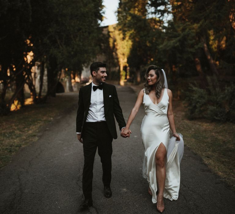 Bride in Silk Pallas Couture Wedding Dress with Plunging Neckline and Side Split | Roman &amp; French Cathedral Veil | Salvatore Ferragamo Nude Bridal Shoes | Groom in Made to Measure Tuxedo Suit by Oscar Hunt | Black Aquila Shoes | Intimate Italian Castle Wedding with Prosecco Tower | James Frost Photography