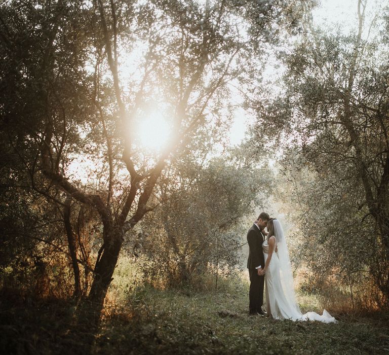 Bride in Silk Pallas Couture Wedding Dress with Plunging Neckline and Side Split | Roman &amp; French Cathedral Veil | Salvatore Ferragamo Nude Bridal Shoes | Groom in Made to Measure Tuxedo Suit by Oscar Hunt | Black Aquila Shoes | Intimate Italian Castle Wedding with Prosecco Tower | James Frost Photography