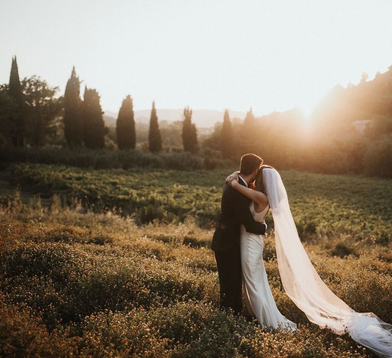 Bride in Silk Pallas Couture Wedding Dress with Plunging Neckline and Side Split | Roman &amp; French Cathedral Veil | Groom in Made to Measure Tuxedo Suit by Oscar Hunt | Intimate Italian Castle Wedding with Prosecco Tower | James Frost Photography