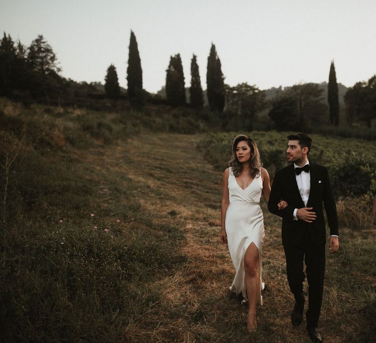 Bride in Silk Pallas Couture Wedding Dress with Plunging Neckline and Side Split | Salvatore Ferragamo Nude Bridal Shoes | Groom in Made to Measure Tuxedo Suit by Oscar Hunt | Black Aquila Shoes | Intimate Italian Castle Wedding with Prosecco Tower | James Frost Photography