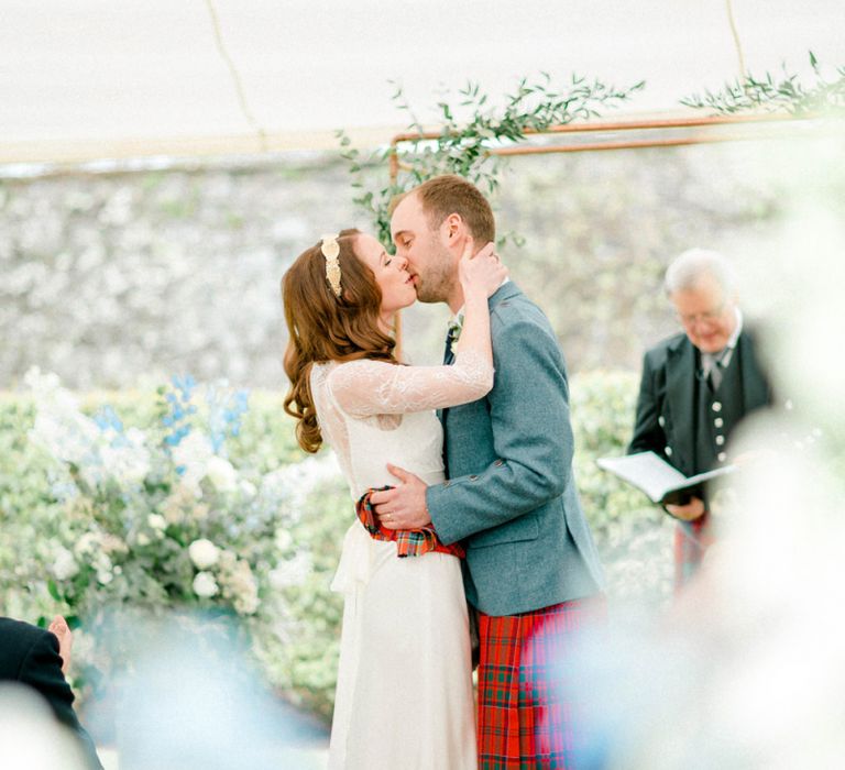 Bride and Groom Kissing at the Altar