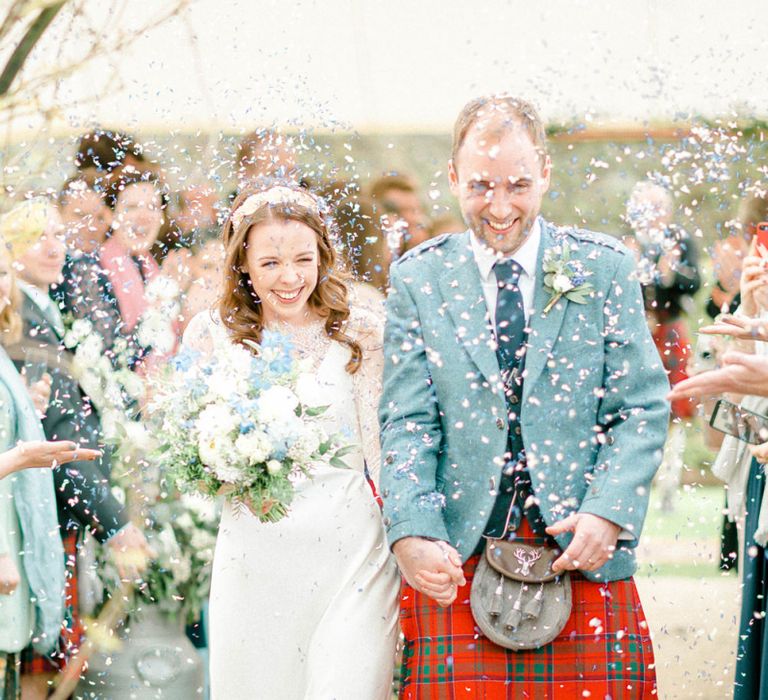 Bride and Groom Wedding Ceremony Exit with Confetti Thrown at Them