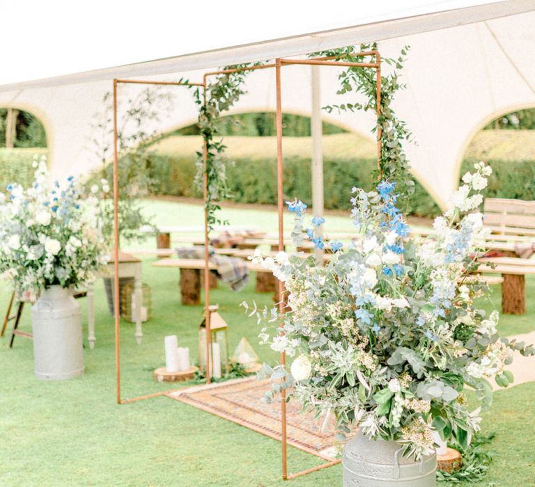 Copper Frame Wedding Altar with Flowers in Milk Churns