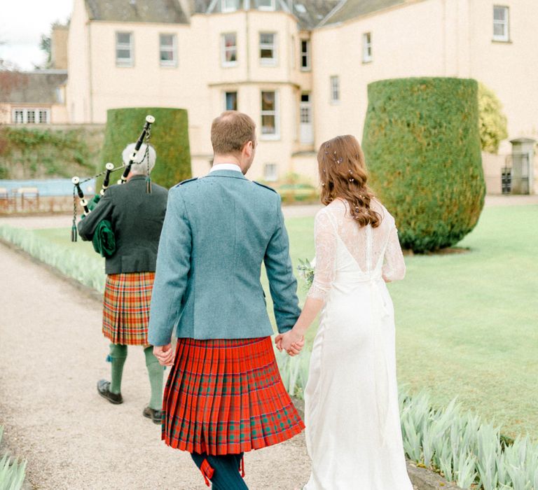 Bag Piper Procession Through Wedding Venue Gardens