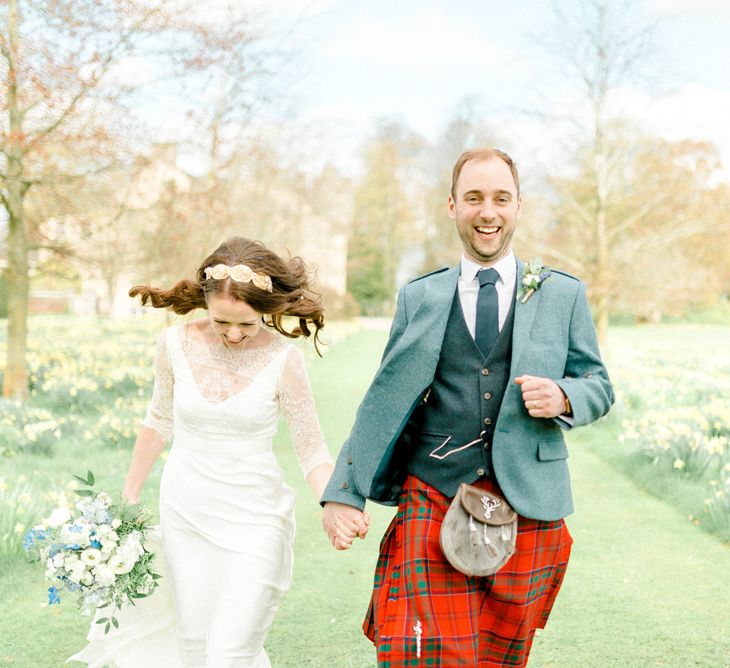 Bride in Charlie Brear Gown and Groom in Tartan Kilt Laughing