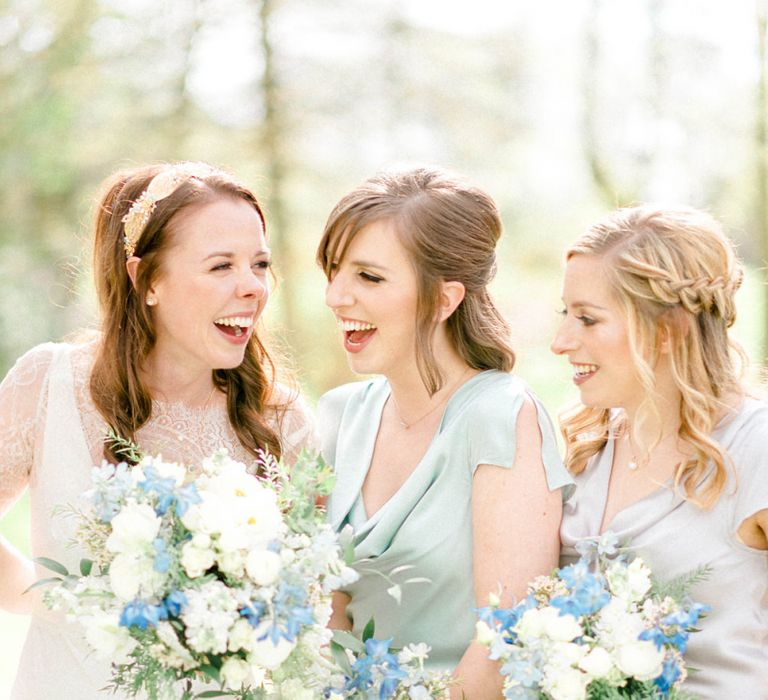 Bridal Party Laughing Holding Blue and White Wedding Bouquets