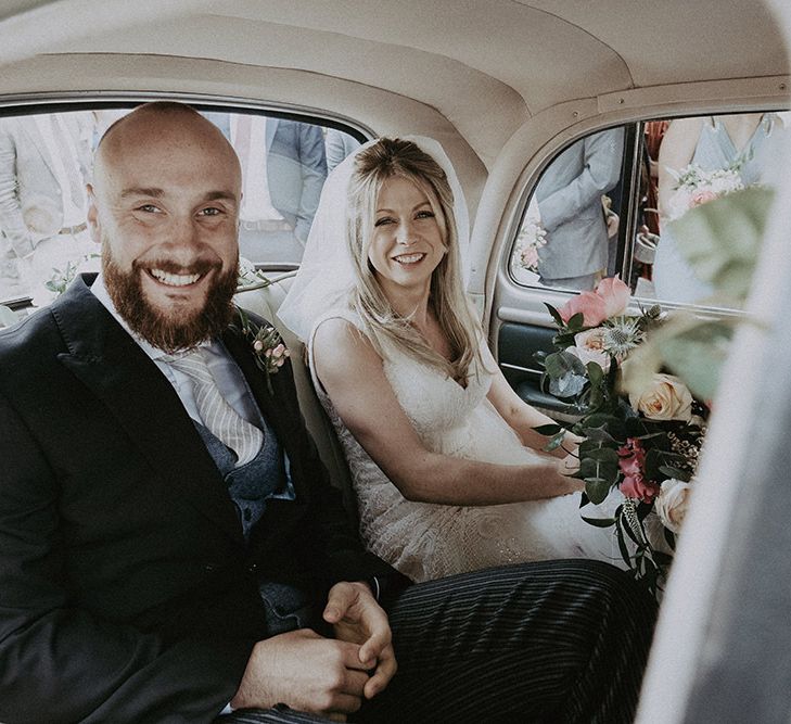 Bride &amp; Groom In Vintage Wedding Car