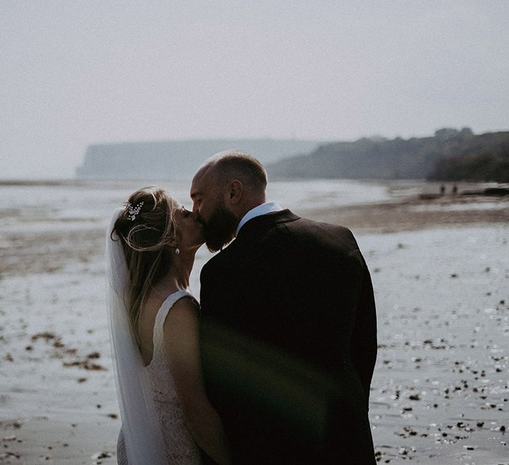 Bride &amp; Groom Kiss on Beach for Isle of Wight Wedding