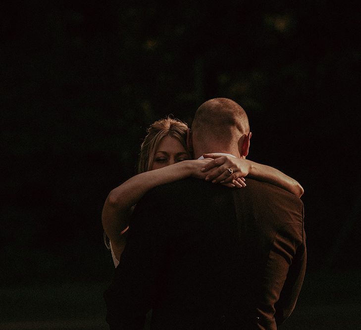 Bride and Groom Embrace At Wedding