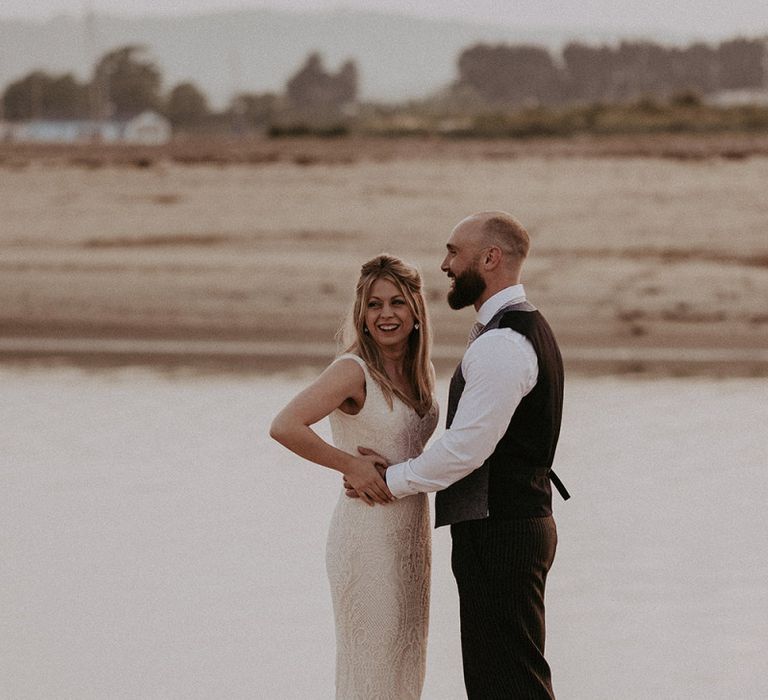 Bride wearing Lace Blush Dress with Groom in Waistcoat