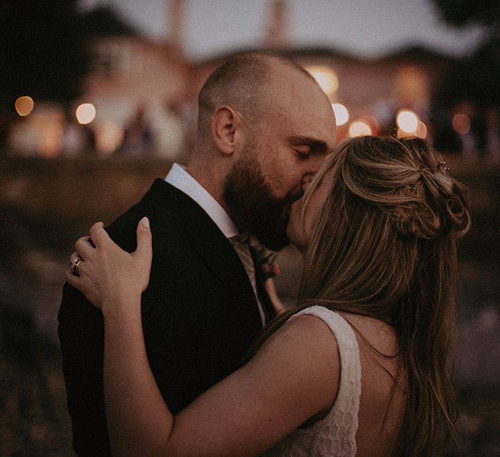 Pontoon Lighting Behind Bride and Groom