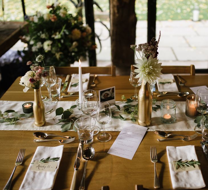 Wedding Reception Table Decor with Gold Spray Painted Bottles, Candle Light and Greenery Decor