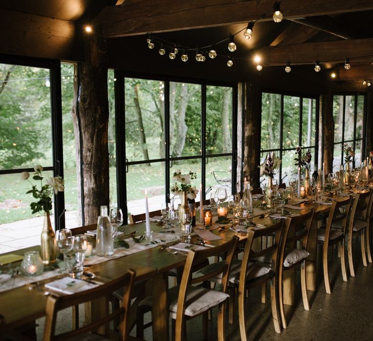 Barn Wedding Reception Decor with Festoon Lights and Candles