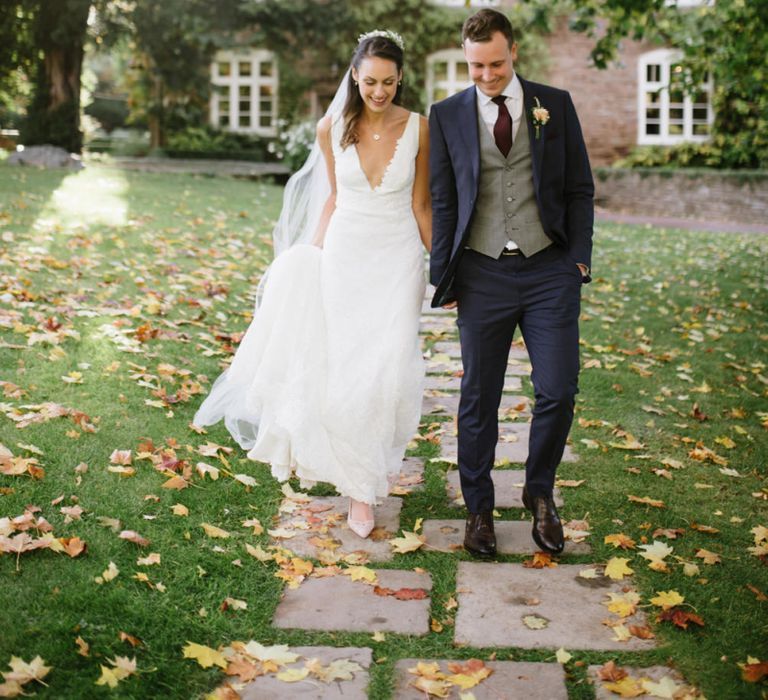 Bride and Groom Wedding Portrait with Autumn Leaves on the Floor