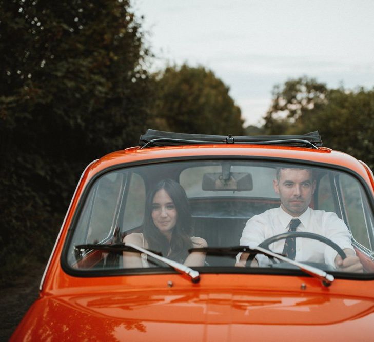 Bride And Groom Drive To Reception In Orange Fiat 500 Wedding Car