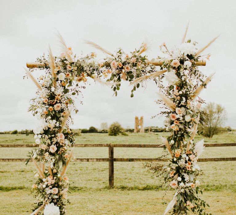 Wooden Frame Covered in Flowers, Foliage and Pampas Grass