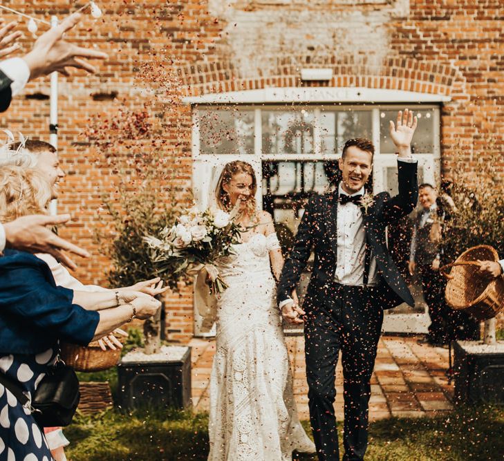 Confetti Moment with Boho Bride in Rue De Seine Wedding Dress and Groom in Black Tie Suit