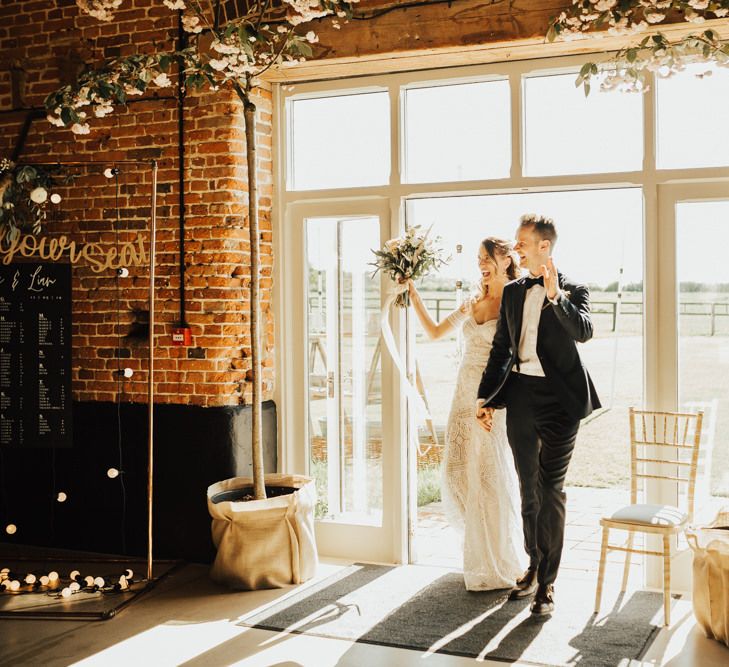 Bride and Groom Entering the Rustic Barn Wedding Reception