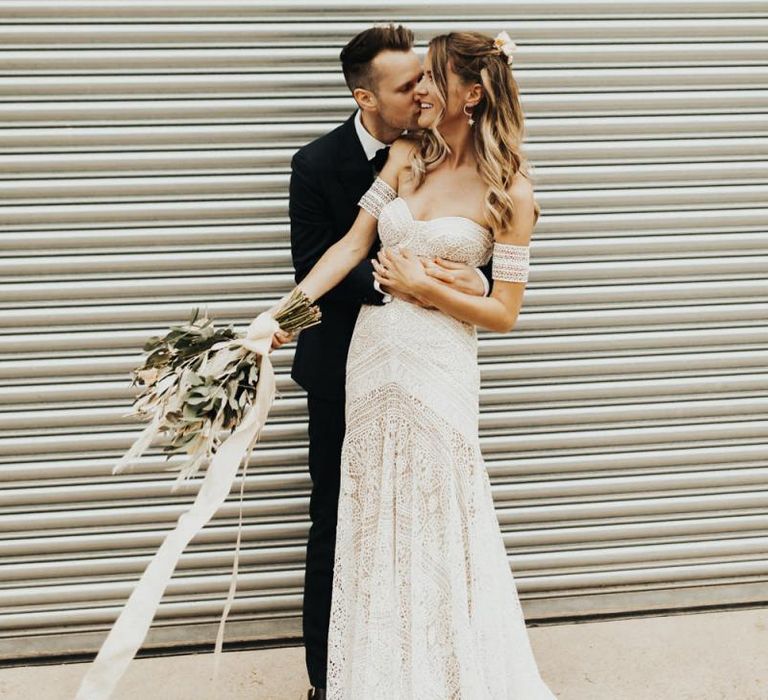 Groom in Black Suit Embracing a Bride in Rue de Seine Wedding Dress