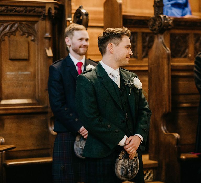 Groom in tartan kilt waiting at the altar