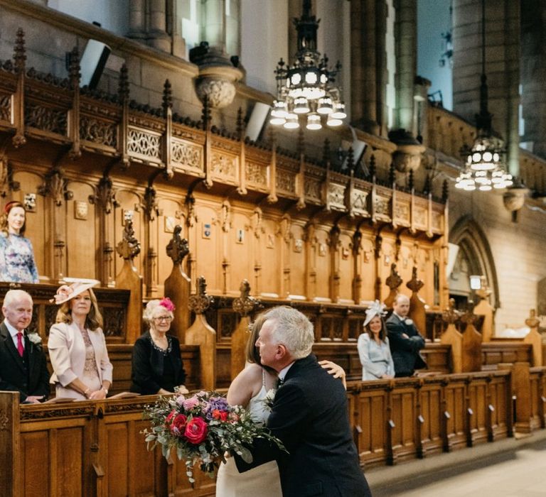 Father of the bride giving his daughter away at Glasgow University Chapel wedding ceremony