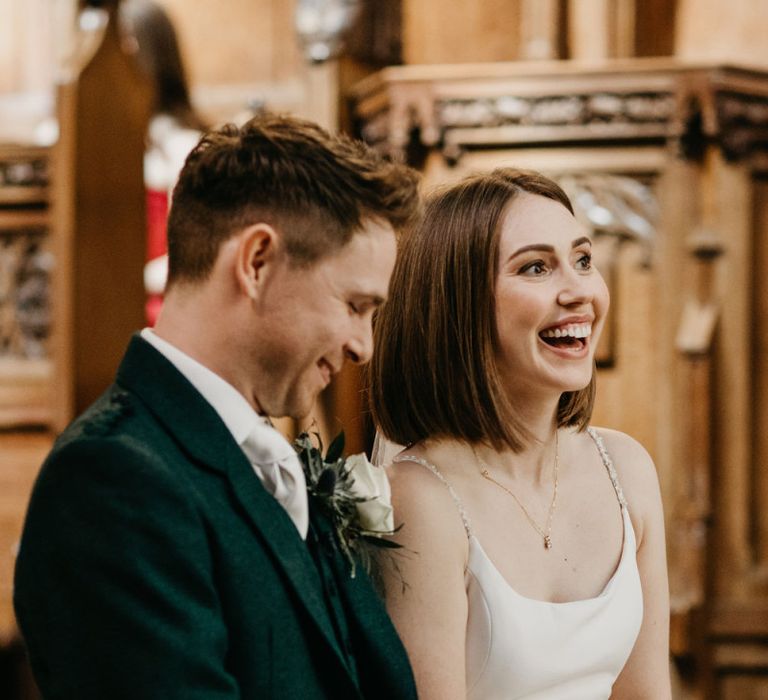 Bride and groom laughing at Glasgow University Chapel  wedding ceremony