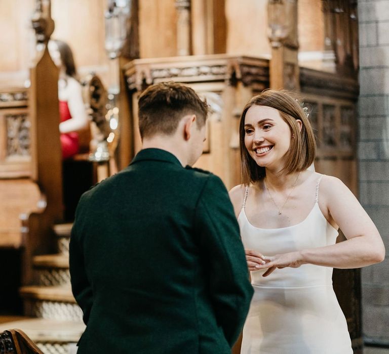 Bride and groom exchanging vows at Glasgow University Chapel  wedding ceremony