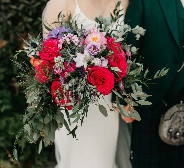 Colourful red, pink and purple wedding bouquet