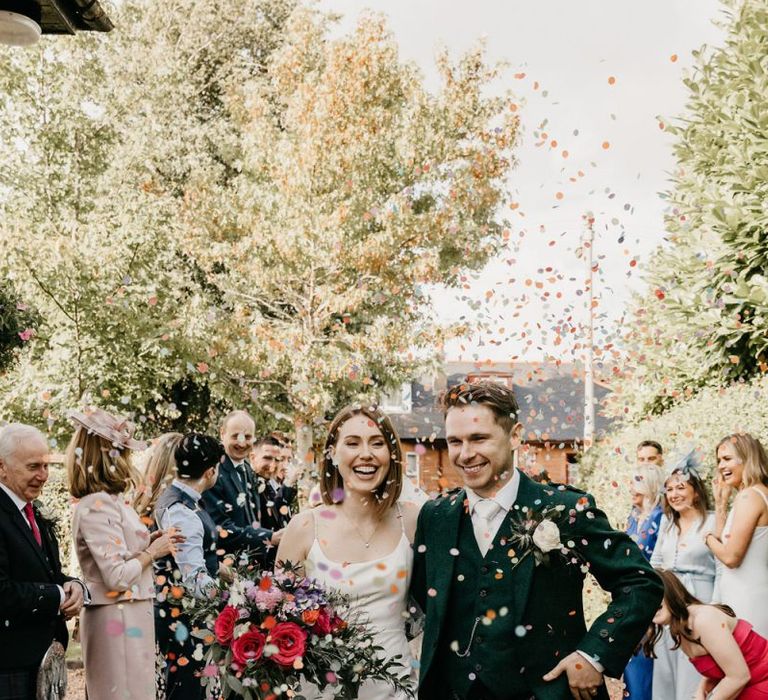 Bride and groom confetti moment by Emma Lawson Photography