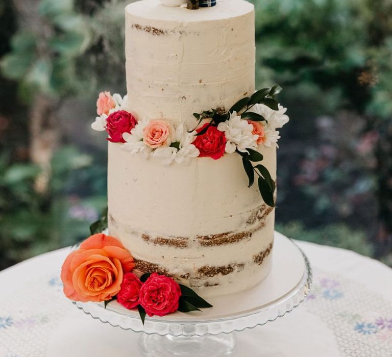 Semi naked wedding cake with people cake topper