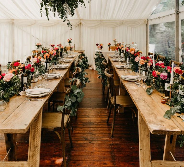 Wooden tables for socially distanced marquee reception