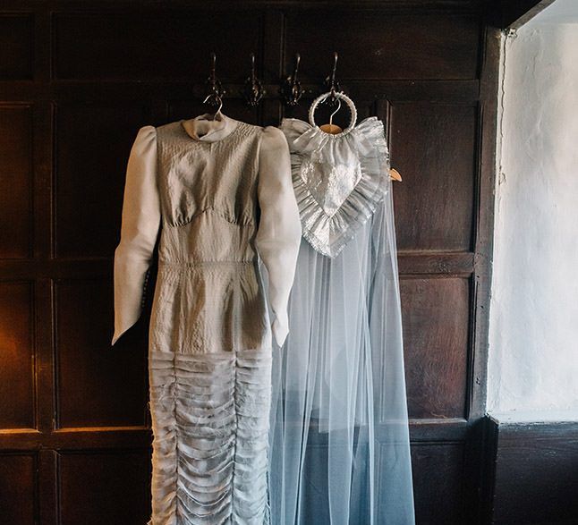 Silver gothic styled wedding dress with long sleeves, cobweb train and corset waist