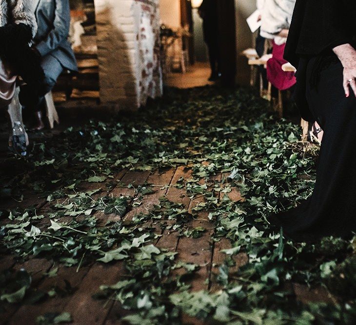 Locally foraged foliage decor at intimate gothic wedding ceremony