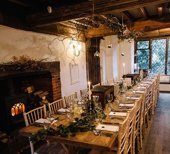 Small intimate reception for winter celebration with foliage decor and candlelight